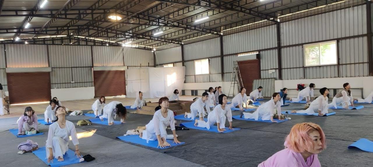 Japanese students practicing yogasana with LiveFit Studio