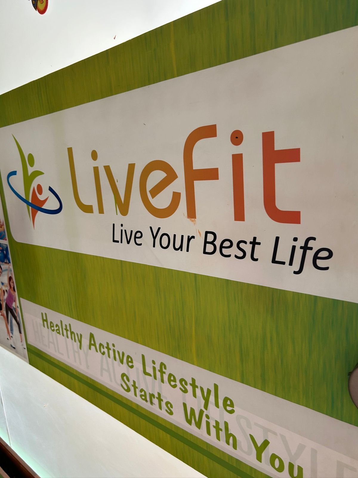 LiveFit brand wall with Live Your Best Life tagline